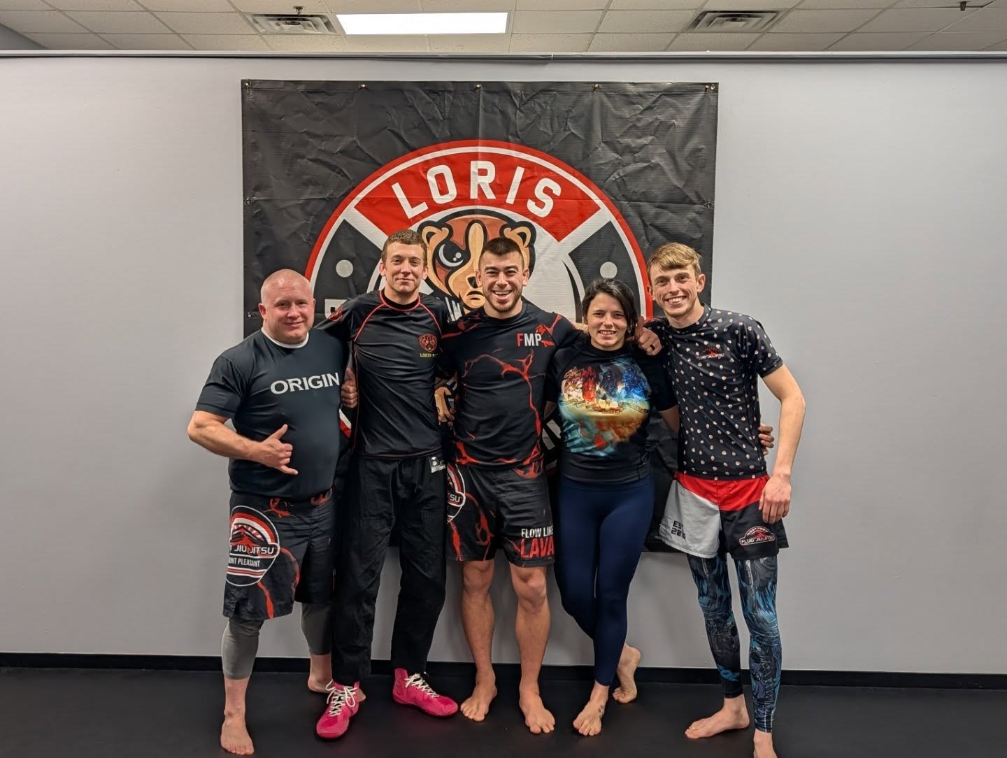 Small group of students standing together on the mats at Loris